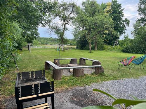 a park with a picnic table and two chairs at Gite La Cigogne in Couvin