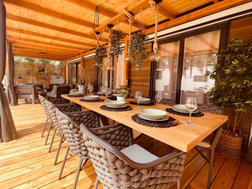 a dining room with a long wooden table and chairs at Pearl of the Biograd in Biograd na Moru