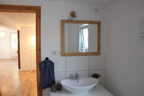 a bathroom with a sink and a mirror at Viel Platz und ungestört für sich in Diepenau