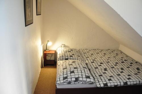 a bedroom with a bed in a attic at Hostel Pestalozza in Špindlerův Mlýn