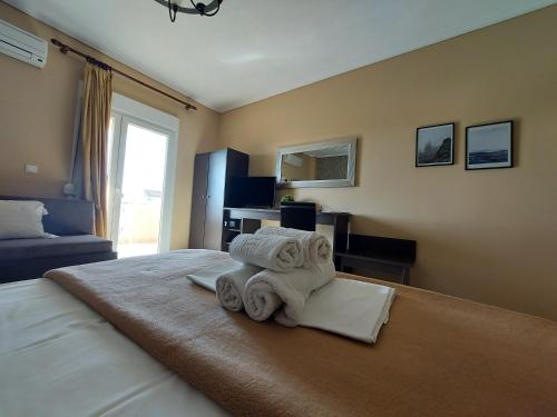a hotel room with towels on a bed at Hotel Epavli in Nea Kalikratia