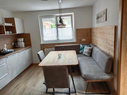 a living room with a table and a couch at Ferienwohnung Fabiella Döbriach in Döbriach