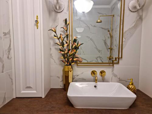 a bathroom with a white sink and a mirror at LUX Apartment Amazing View in Wrocław