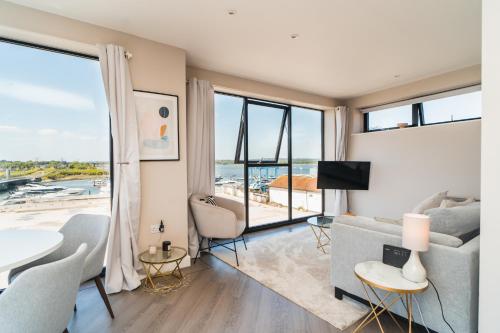 a living room with a view of the ocean at Penthouse - Harbour Views in Poole