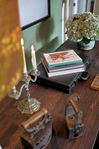 a wooden table with a candle and a book and a candle at Atemporal by Andean in Lima