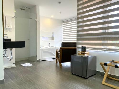 a living room with a sink and a mirror at Seven Inn Hotel in Medellín