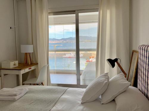 a bedroom with a bed with a view of the ocean at Centro VIGO.NUEVO.TOP BEST VIEWS in Vigo