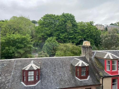 two roofs of houses with red windows and trees at Our Wee Getaway in Rothesay