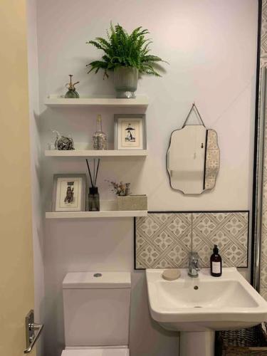 a bathroom with a white sink and a toilet at The Nest, central Ludlow one bed apartment in Ludlow