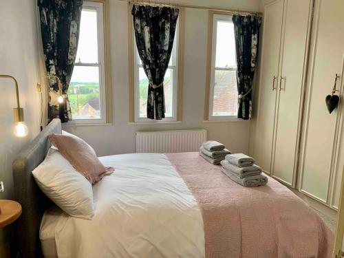 a bedroom with a bed with towels on it at The Nest, central Ludlow one bed apartment in Ludlow