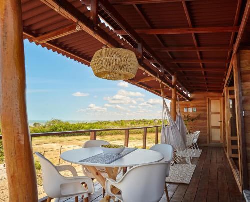 a patio with a table and chairs on a deck at Corazon Guajiro Cabaña frente a Playa Solitaria en Dibulla cerca a Palomino - Cabin in front of Solitary Beachs in Dibulla