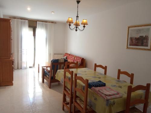 a dining room with a table and chairs in a room at APARTAMENTS CASA NANDO. in Esterri d'Àneu