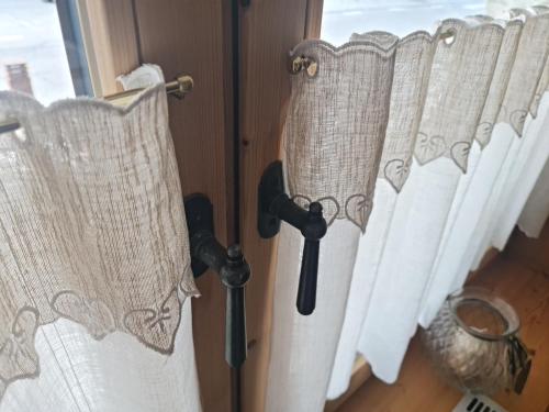 a group of white curtains on a window at Hotel Traube - Stelvio in Stelvio