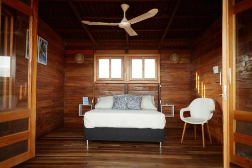 a bedroom with a bed and a ceiling fan at Corazon Guajiro Cabaña frente a Playa Solitaria en Dibulla cerca a Palomino - Cabin in front of Solitary Beachs in Dibulla