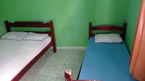 Ένα ή περισσότερα κρεβάτια σε δωμάτιο στο Pousada/suites Praia Grande III