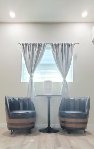 a room with two chairs and a table and a window at King Size Sassy Studio in St. Petersburg