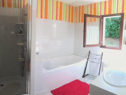 a bathroom with a bath tub and a sink at Gîte Le Mayet-de-Montagne, 4 pièces, 6 personnes - FR-1-489-317 in Le Mayet-de-Montagne