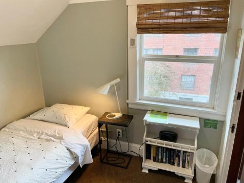 a small bedroom with a bed and a window at Portland International Guesthouse in Portland