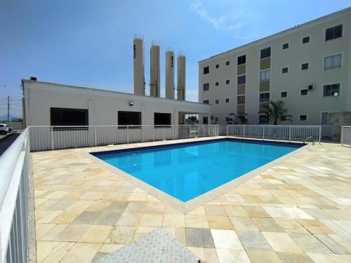 a swimming pool in front of a building at MAR & SOL Apartamentos I - Free Wi-Fi in Rio das Ostras