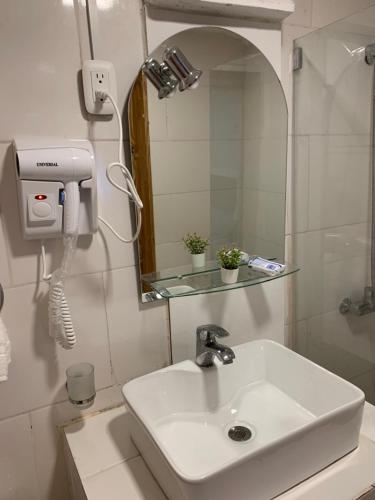 a bathroom with a white sink and a mirror at Noe Hotel ,1 Bed Room 2 Near to the beach in Punta Cana