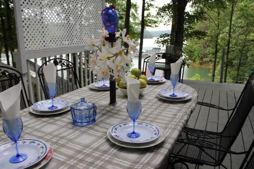 a table with blue and white plates and glasses at Paradise View Getaway-Dacha in Hartwell
