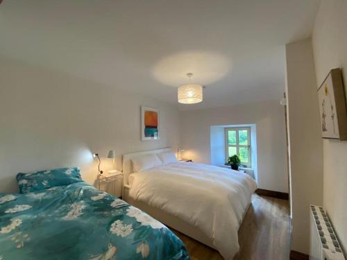a bedroom with two beds and a window at 3 Bed Apartment/Explore the Area/Enjoy our Pub in Galway
