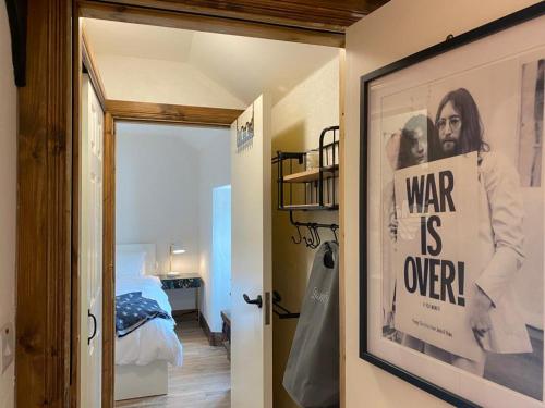 a room with a poster of a war is over at 3 Bed Apartment/Explore the Area/Enjoy our Pub in Galway