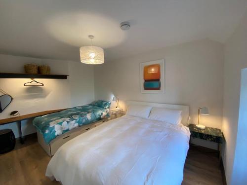 a bedroom with a large white bed and a desk at 3 Bed Apartment/Explore the Area/Enjoy our Pub in Galway