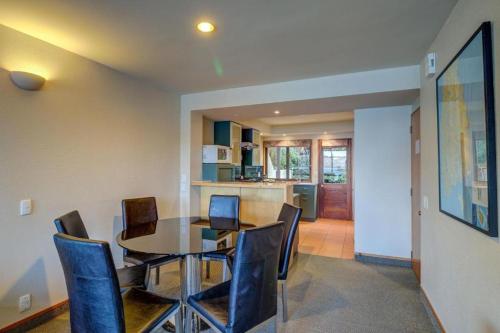 a dining room with a table and chairs at Lakefront Apartments,18 LAKE ESPLANADE ROAD in Queenstown