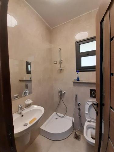 a bathroom with a sink and a toilet at Near Mall Masr - Families only - 6 october - Luxury town house in 6th Of October