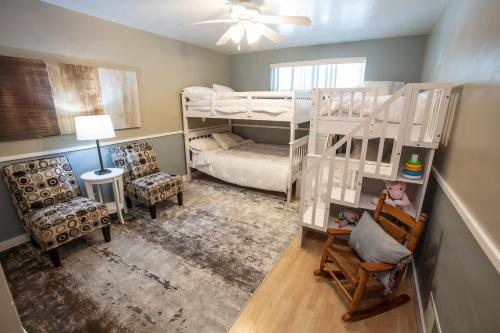 a small room with a bunk bed and a chair at Comfortable Bungalow near Liberty Park in Salt Lake City