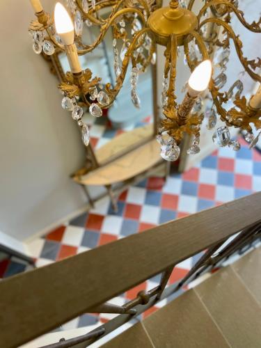 a chandelier is hanging over a checkered table at Villa Marengo Guest House in Spinetta Marengo