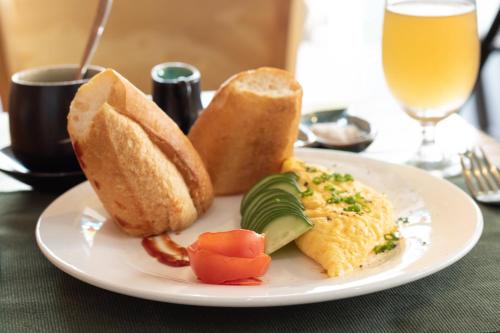 a plate of food with bread and eggs and toast at HOI AN HEART LODGE in Hoi An