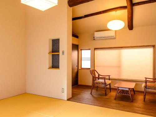 a classroom with a table and chairs and a chalkboard at Koume no Hanare コウメノハナレ in Kyoto