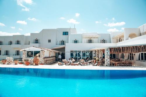 a hotel with a swimming pool in front of a building at Selina Paros in Pounda