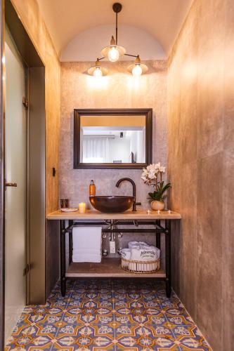 a bathroom with a sink and a mirror at Alkionides Rooms in Polychrono
