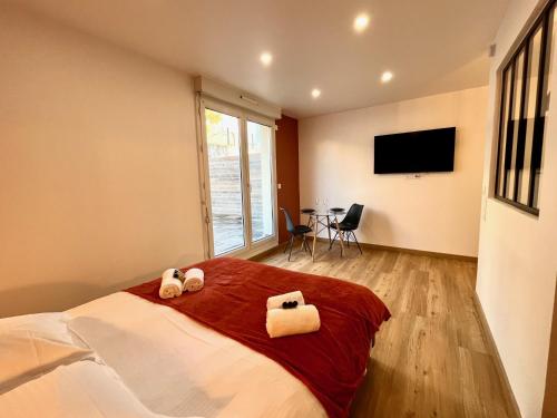 a bedroom with a bed with two towels on it at Studio avec grande terrasse et parking privatifs in Caen