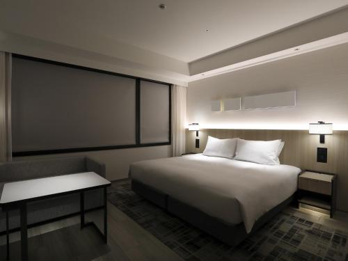 a hotel room with a bed and a large window at Hyatt Place Kyoto in Kyoto