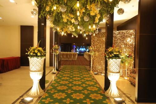 a aisle with lights and flowers in a room at Vivanta Jamshedpur, Golmuri in Jamshedpur