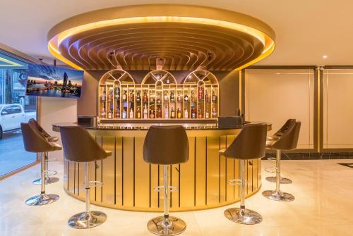 a bar with a bunch of bottles of alcohol at GLOW Sukhumvit 5 in Bangkok