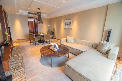 a living room with a couch and a table at Marco Polo Ortigas Manila in Manila