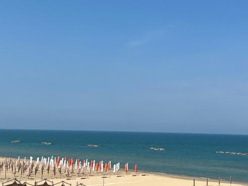 a beach with many umbrellas and the ocean at Adream in Pescara