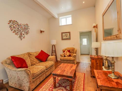 a living room with a couch and a table at The Stables in Millom