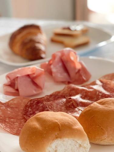 a plate of food with meats and pastries on it at La Minditta in San Teodoro