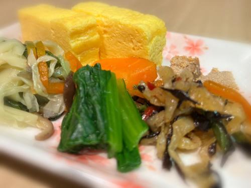a plate of food with vegetables and bread at Tmark City Hotel Kanazawa in Kanazawa