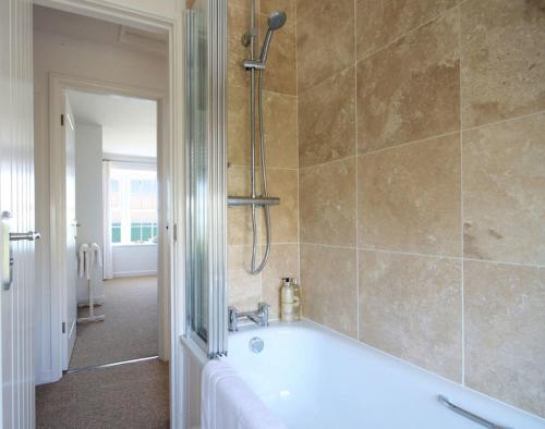 a bathroom with a bath tub and a shower at Castaway in Port Isaac