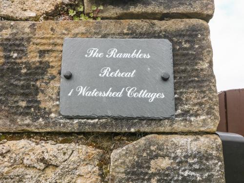a sign on the side of a stone wall at Ramblers Retreat in Settle