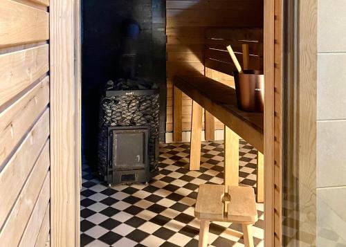 a stove in a room with a checkered floor at SÖRWESPA Nature Resort in Salme