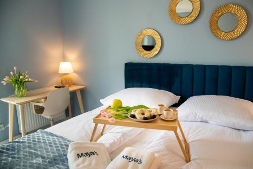 a hotel room with a tray of food on a bed at Maya's Flats & Resorts 52 - Aura 40 in Gdańsk