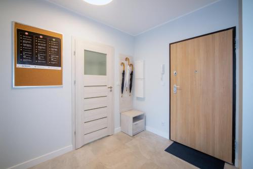 a room with a door and a closet at Maya's Flats & Resorts 52 - Aura 40 in Gdańsk